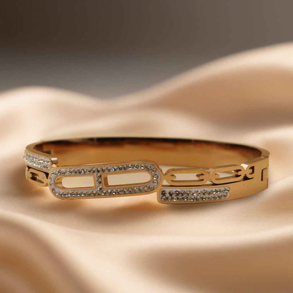 Contemporary Gold Tone Bangle with Linked Crystal Pattern