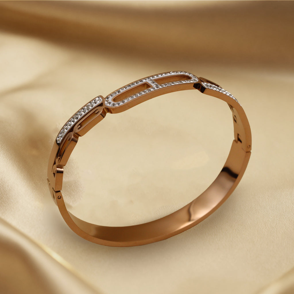 Contemporary Gold Tone Bangle with Linked Crystal Pattern