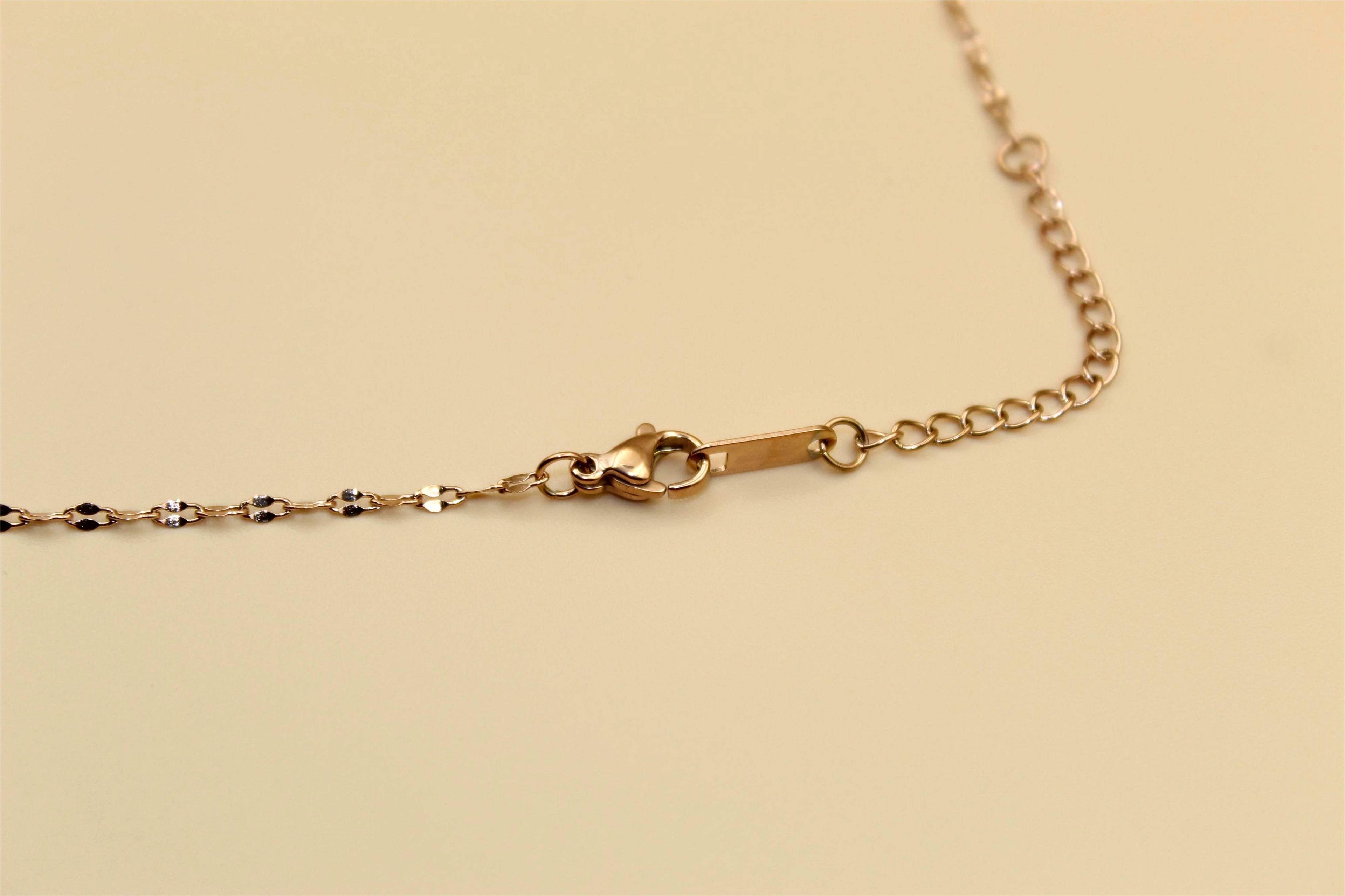 Gold-tone chain adorned with elegant aqua blue stone